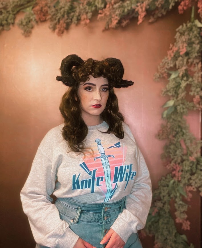 Knife Wife sweatshirt in an 80s style print. Modeled by Jude Duarte 