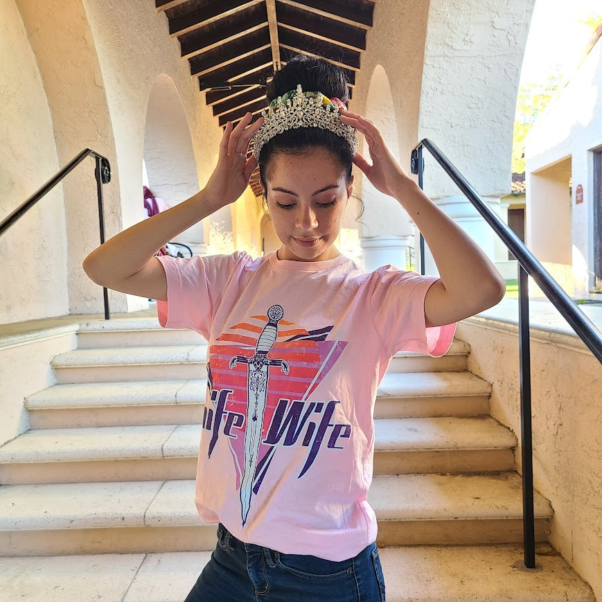 Knife Wife sweatshirt in an 80s style print modeled at a college campus with a tiara 