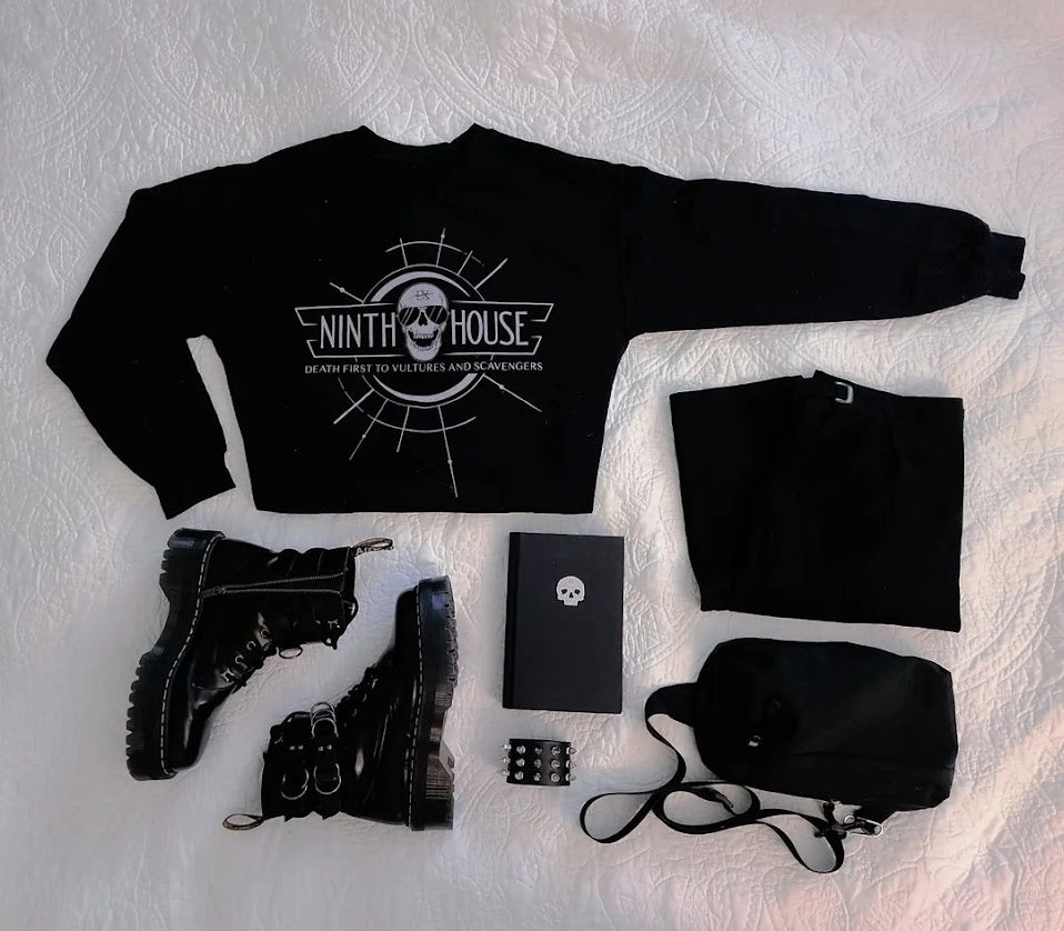 Gideon the ninth themed ninth house sweatshirt in black on a flatlay with skull and the phrase "death first to vultures and scavengers" 