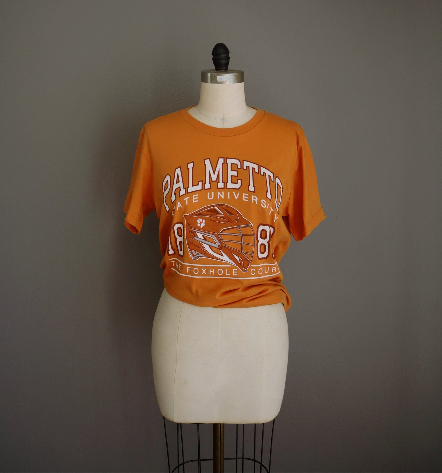 Palmetto shirt in orange on a mannequin 