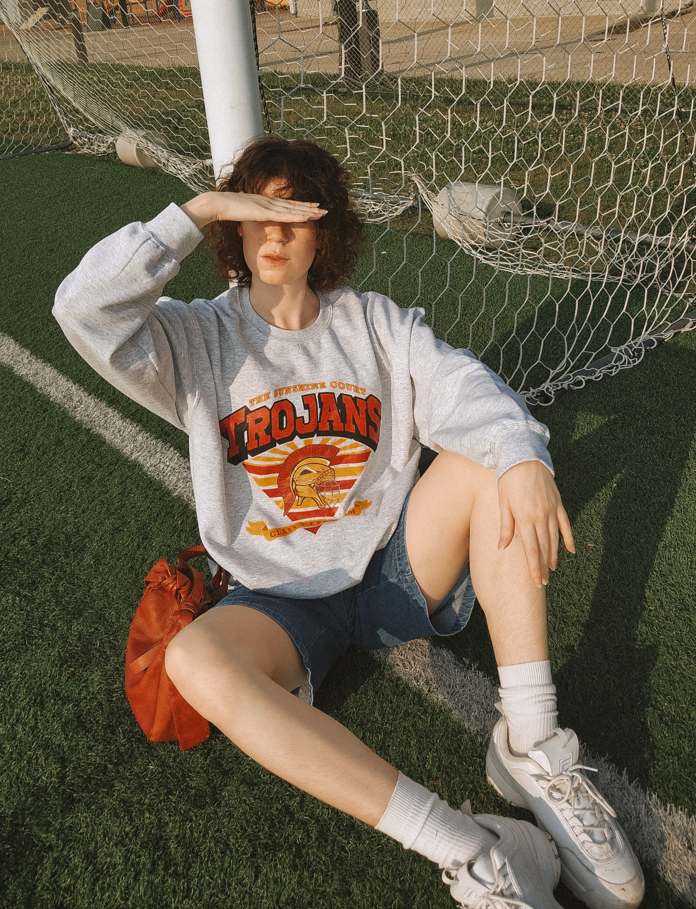 Model wearing the Trojan Sunshine Court sweatshirt in grey