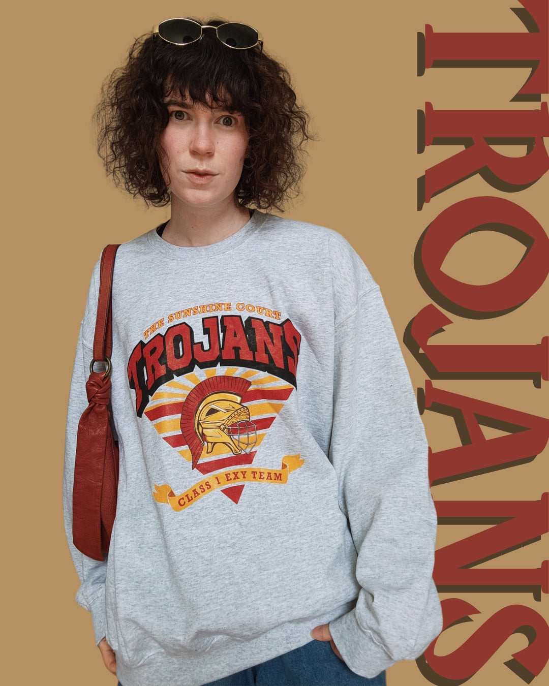 Trojan Sunshine Court Sweatshirt in Grey with the word trojans behind the model