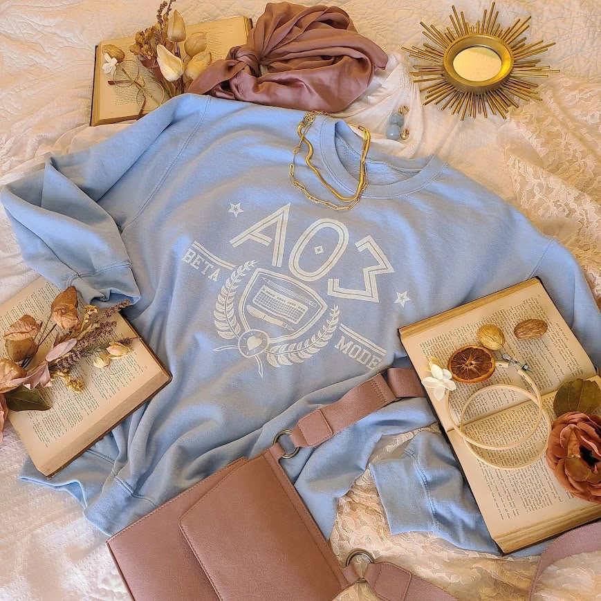 Flatlay of the fanfic website inspired shirt with a sorority themed design. 